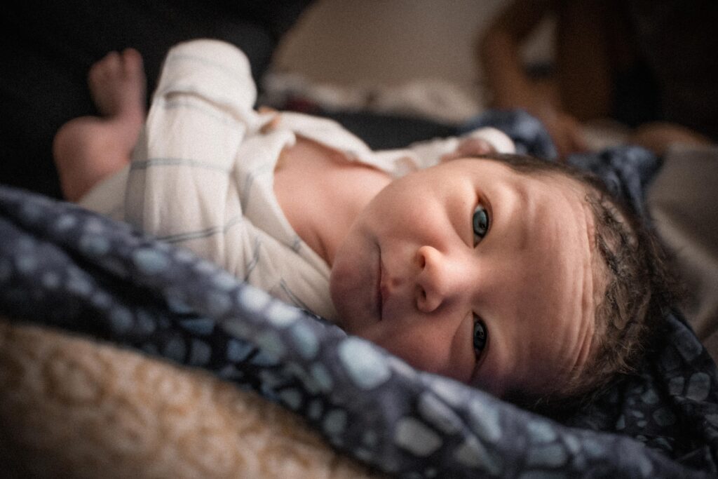 Baby looking at camera After Homebirth during Fresh 48 photography session in Sacramento, CA