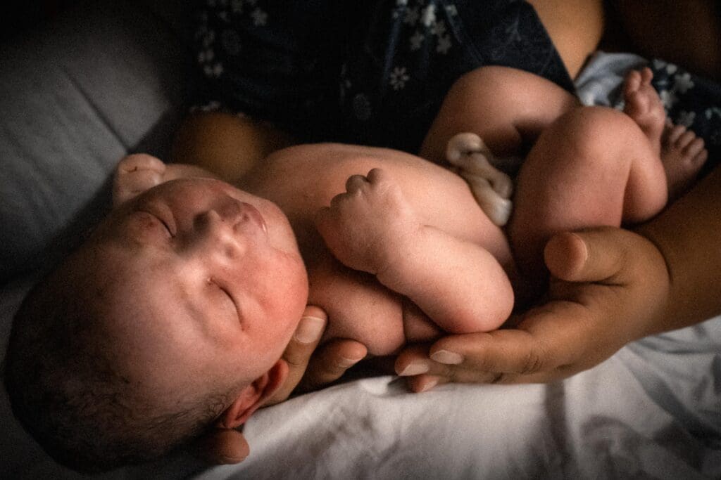 Newborn Baby in Mother's Hands after Homebirth during Fresh 48 Session in Sacramento, CA